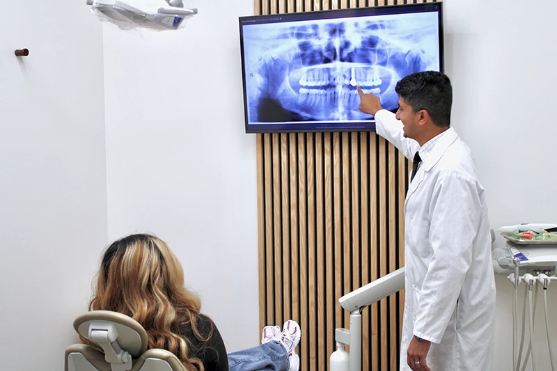 Dr. Amjad Ali showing a patient their x-rays