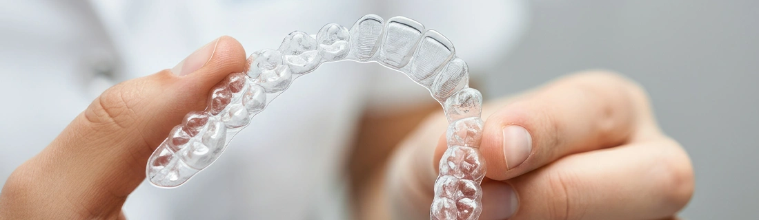 A dentist showing off clear aligners