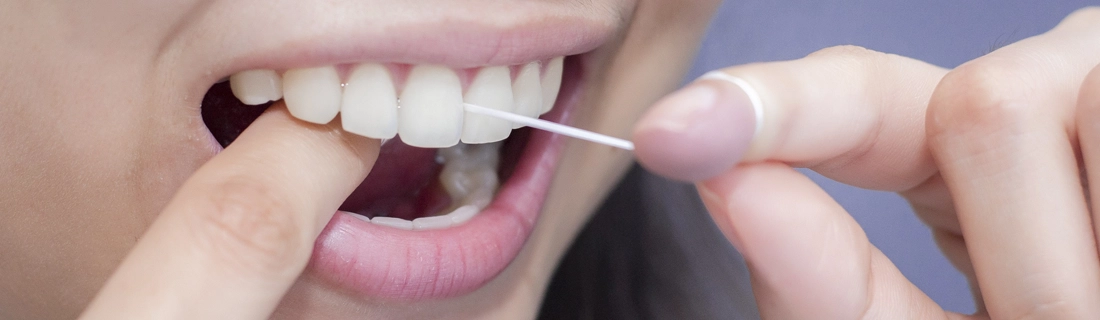 A patient flossing their teeth
